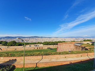 Fototapeta na wymiar Ancient fortification walls and Barcelona panorama