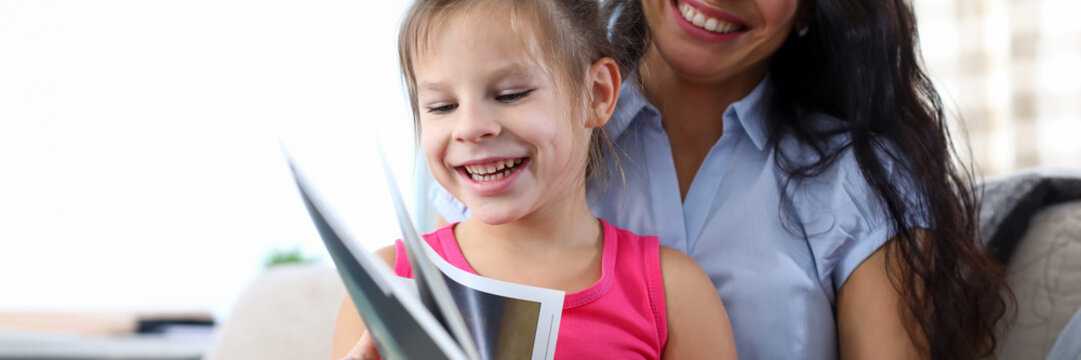 Mum reading book with child