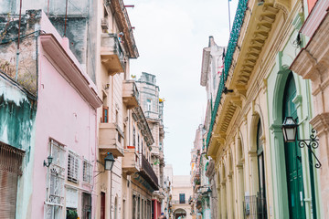Fototapeta na wymiar Authentic view of a street of Old Havana with old buildings and cars