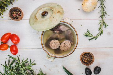 liverwurst in broth. soup with a pot.