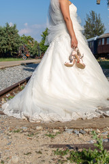 Fototapeta na wymiar bride walking the railway, wedding concept