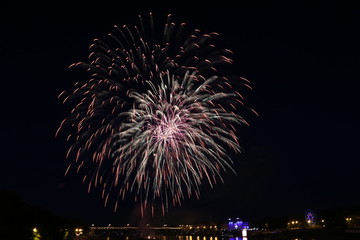 Salute on city day in Tver on the background of the bridge over the Volga river