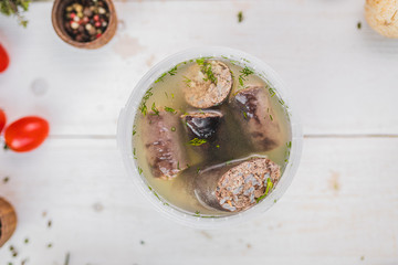 liverwurst in broth. soup with a pot.