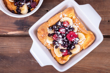 dutch German pancake topped with bluberries berries fruit and banana