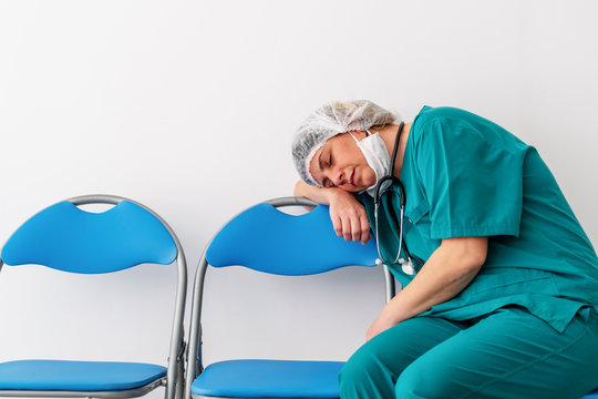 Woman doctor is sitting and fall asleep, because of worry, frustration, tiredness and exhausting of global infection covid-19.