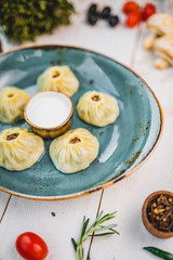 Uyghur manti on a blue plate. national asian dish. beautiful serving