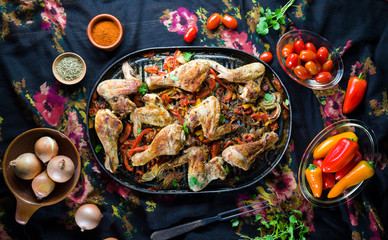 Roasted chicken leg with vegetables and spices.