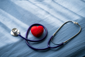 Medical stethoscope and red heart on Patient's bed.Concept healthcare.
