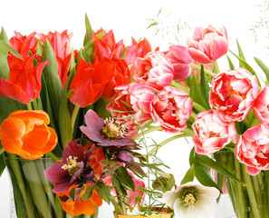 Obraz na płótnie Canvas Bright bouquets of tulips, festive spring composition on a white background