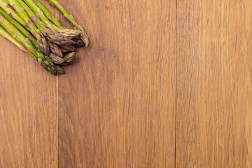 Fresh asparagus lie on the board