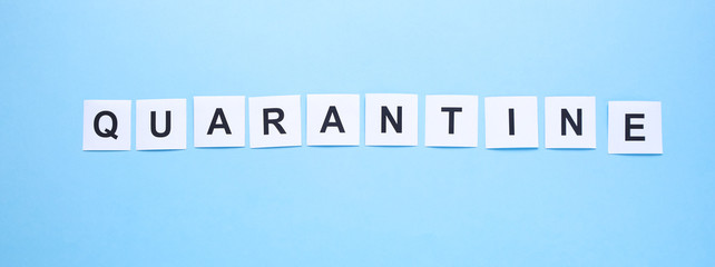 The word quarantine written on a blue background