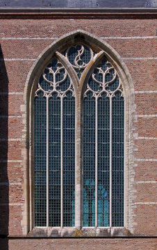 Pointed ogive arch with gothic window at the brick facade of Brouwershaven city church in the Netherlands