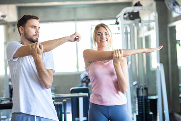 Fototapeta na wymiar Sport couple stretching muscle before sport activity in fitness gym club