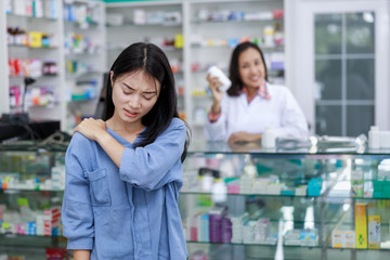 female patient shouldder pain in pharmacy Thailand