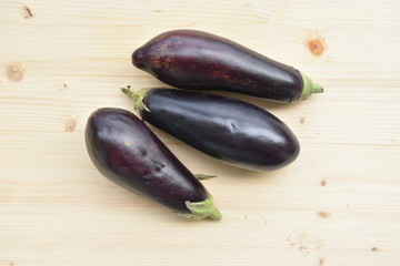 Fresh Eggplants on Wooden Table