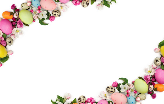 Easter decoration. Frame of pink flowers apple tree and colored easter eggs and quail eggs on white background with space for text. Top view, flat lay