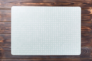 Top view of empty green table napkin for dinner on wooden background with copy space