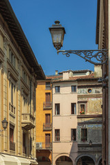 A Street Of Mantua. Lanterns and old murals on the walls of houses. Italy. Soft focus and blurry background.