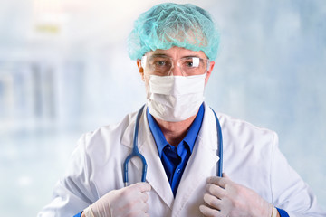 Doctor with face shields and uniform in hospital corridor