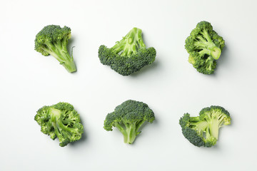 Flat lay with broccoli on white background, top view
