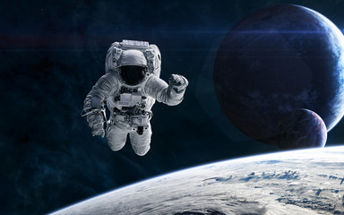 Astronaut on the background of planets in deep space. Science fiction. Elements of this image furnished by NASA