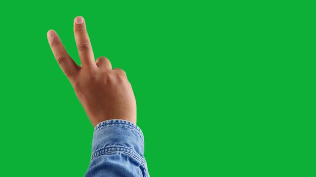 mixed race deep skin tone male hand makes a zoom gesture one click keying on chromakey green