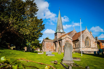Fototapeta na wymiar Old English church with graveyard