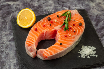 Fresh fish. Salmon steak on black board.