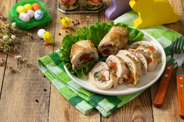 Festive appetizer. Chicken meatloaf with dried apricots, mozzarella and herbs on a festive Easter table. Copy space.