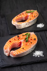 Fresh fish. Salmon steak on black board.
