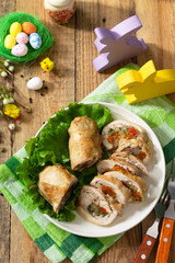 Festive appetizer. Chicken meatloaf with dried apricots, mozzarella and herbs on a festive Easter table.