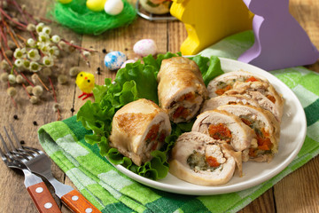 Festive appetizer. Chicken meatloaf with dried apricots, mozzarella and herbs on a festive Easter table.
