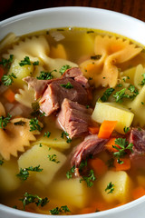 Soup with smoked meat, vegetables and pasta