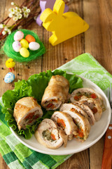 Festive appetizer. Chicken meatloaf with dried apricots, mozzarella and herbs on a festive Easter table.