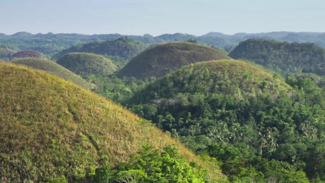 Chocolate Hills on a bright summer day, Bohol, Philippines, slowmo panning