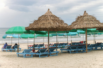 Tourists lying on sunbeds in China Beach in Da Nang