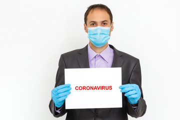 Close up of a businessman in a suit wearing Protective face mask, get ready for Coronavirus and pm 2.5 fighting against gray background. Healthcare concept.