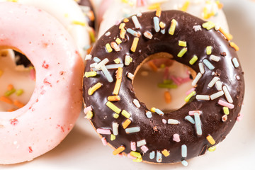 Donuts and coffee on wooden table.