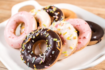Donuts and coffee on wooden table.