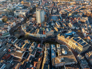 Aerial view of the historic city center of Utrecht during golden hour, with  beautiful architecture and curving canal
