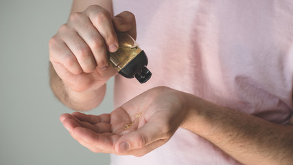 Hand sanitizer gel in a male hands. Hands protection in prevention for coronavirus