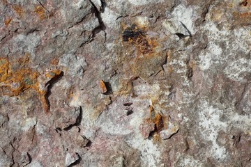 A close view of the dirty hard rock surface.