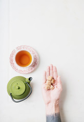 Fototapeta na wymiar Cup of herbal tea. Hand serving.
