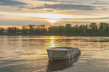 Waterscape with a boat at the river at sunset.