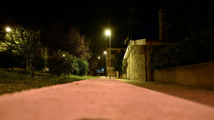 Obraz premium Night Illuminated Park in the City Near the Houses