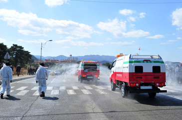 Fumigator truck is conducting COVID-19 disinfection at the city street in South Korea.