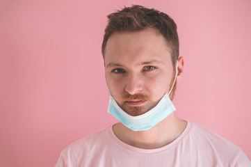 A man in a viral mask on a pink background, wearing face protection in prevention for coronavirus