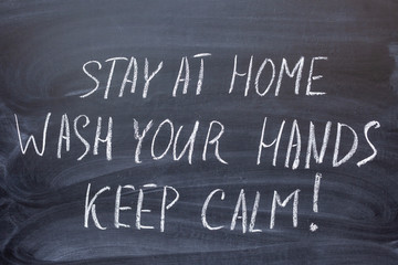 Fototapeta premium Coronavirus pandemic behaviour rules or health advice. Text in Russian on a chalkboard 1) stay at home 2) wash your hands 3) keep calm. The text on the chalk Board