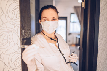 Woman doctor nurse wearing protective mask and stethoscope for check breathing, corona virus prevention, hygiene to stop spreading coronavirus. Avoid contaminating Corona virus Covid-19 concept