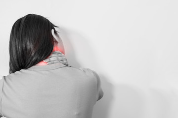 Fototapeta premium white isolated portrait sick and neck pain feeling of woman 30s to 40s with monochrome and red spot on hurt point